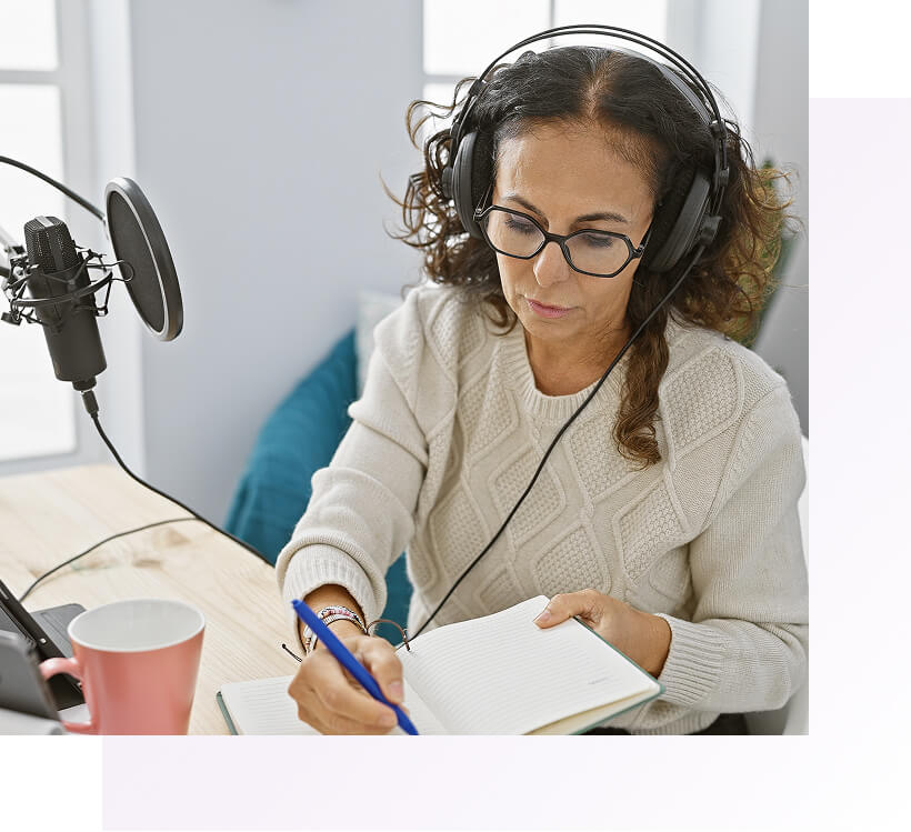 Female finance professional with headset taking notes while learning about the CFI affiliate program