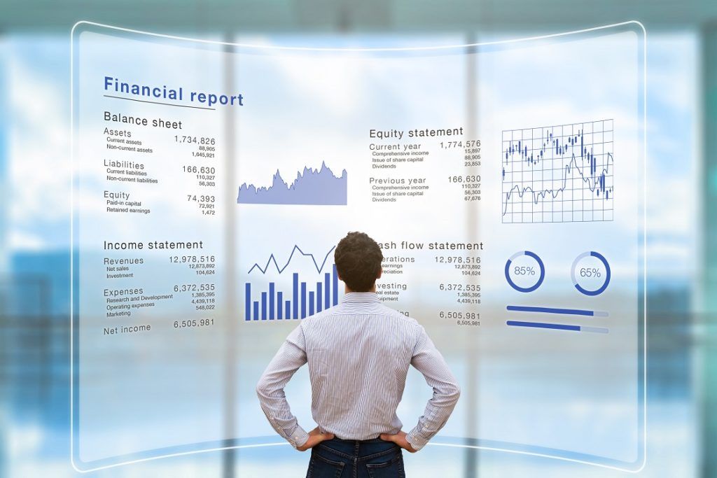Managerial Accounting - Image of a business executive looking a financial report projected to an LCD wall
